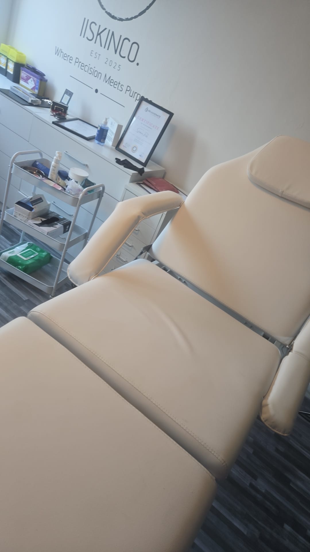 Treatment chair beside a framed certificate
