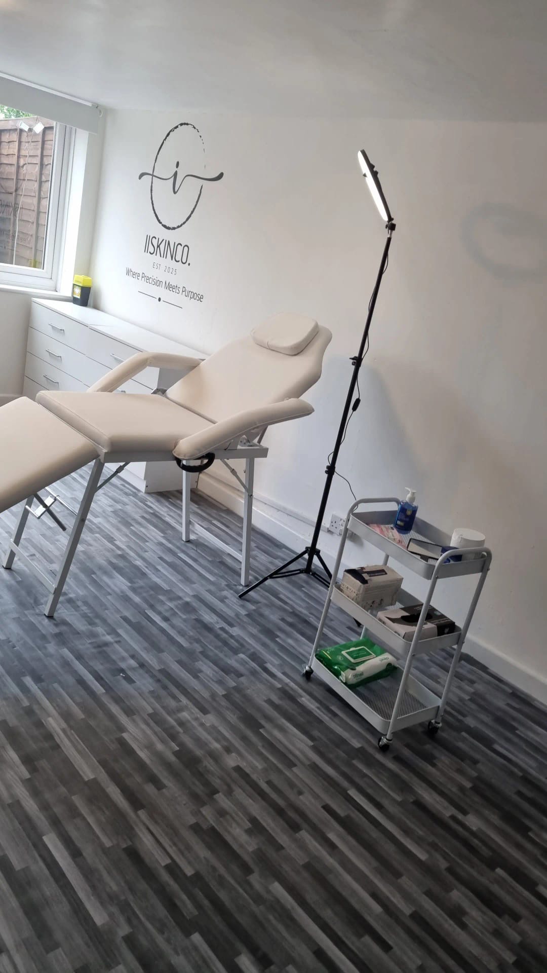 Treatment room with bed, ring light and trolley